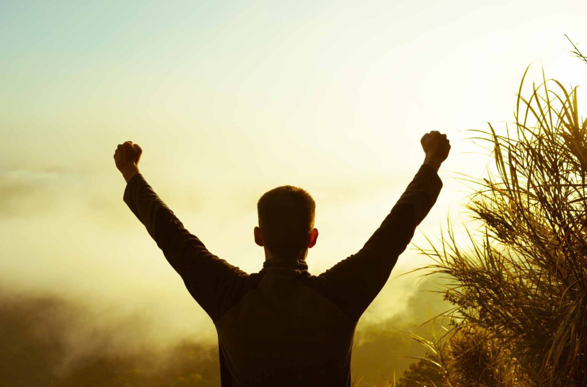 young man celebrating finding help through a transitional living program