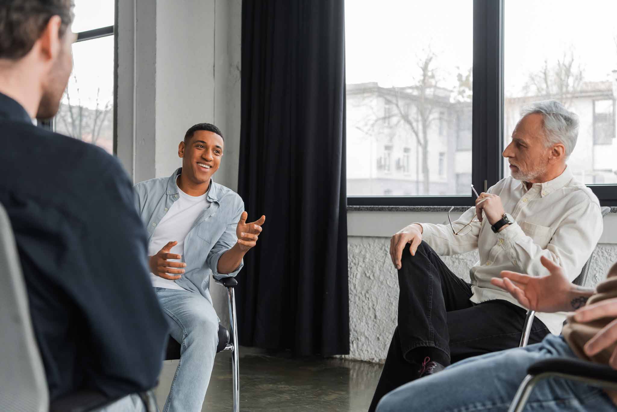 young man celebrating success in transitional living for men